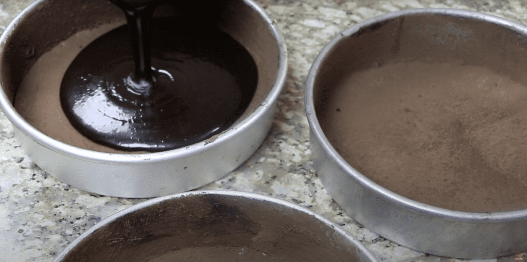 pouring cake batter in the pans